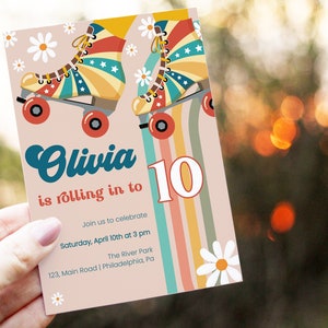 May include: A pink and white invitation with a rainbow stripe background. The invitation features a pair of roller skates with a red, white, and blue design. The text on the invitation reads "Olivia is rolling in to 10. Join us to celebrate Saturday, April 10th at 3 pm The River Park 123, Main Road | Philadelphia, Pa"