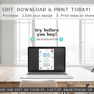 May include: A laptop computer displaying a printable Halloween baby shower invitation with the text "It's a Boo!" and a cute cartoon ghost. The invitation is blue and white with a black and white spider web design. The text "try before you buy!" is displayed above the laptop screen. The laptop is on a wooden table with a white coaster and a green plant in a white pot.