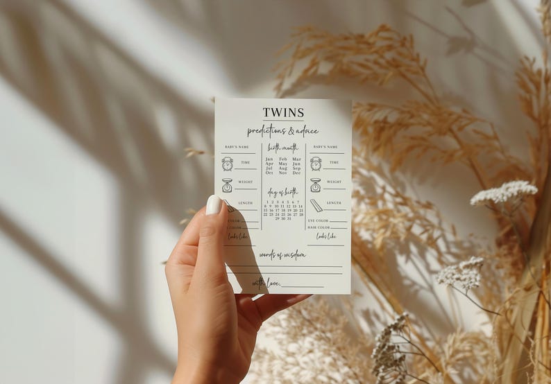 May include: A white card with the word "TWINS" in black script at the top. The card has a list of predictions and advice for twins, including birth month, day of birth, weight, eye colour, hair colour, and what they look like. The card also has a section for "words of wisdom" and a space to write "with love."