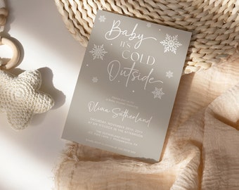 May include: A grey baby shower invitation with white snowflakes and the text "Baby It's Cold Outside" and "Olivia Sutherland". The invitation includes the date, time, and location of the shower.