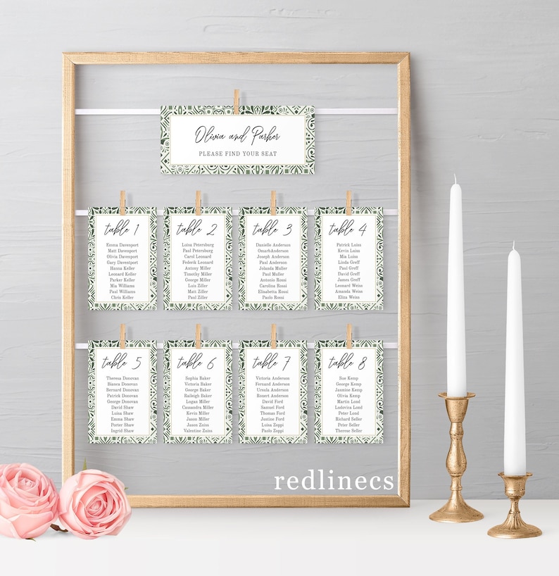 May include: A set of eight table cards with a green and white geometric pattern. Each card has a table number and a list of names. The cards are hanging from a wooden frame with clothespins. The text on the top card reads "Olivia and Parker, Please Find Your Seat."