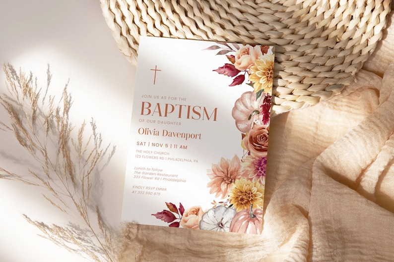 May include: A white baptism invitation with a gold cross and the text "Join us as for the Baptism of our daughter Olivia Davenport Sat Nov 5 11 AM The Holy Church 123 Flowers Rd Philadelphia PA Lunch to follow The Garden Restaurant 333 Flower Rd Philadelphia PA Kindly RSVP Emma at 333 590 875". The invitation is decorated with watercolor illustrations of fall flowers, leaves, and pumpkins.