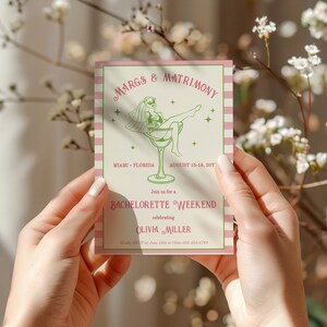May include: A pink and white striped invitation card with green text. The card features a cartoon illustration of a woman in a white veil and a green swimsuit sitting in a martini glass. The text reads "Margs & Matrimony", "Miami - Florida", "August 15-18, 201", "Join us for a Bachelorette Weekend", "celebrating Olivia Miller".