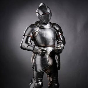 May include: A full suit of polished steel plate armour featuring a closed helmet with a visor, a breastplate, articulated pauldrons, gauntlets, and leg defences. The metallic armour is secured with brown leather straps and rivets throughout the design.