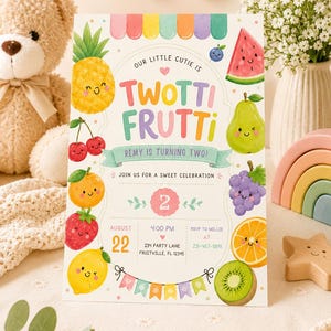 May include: A rectangular party invitation card featuring colorful illustrations of smiling fruits including a pineapple, watermelon, pear, grapes, orange, strawberry, lemon, and kiwi. The text reads: Our little cutie is Twotti Frutti, Remy is turning two.