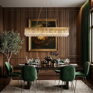 May include: A rectangular chandelier with a gold-toned frame and multiple tiers of clear, faceted crystal prisms hanging from the base. The fixture is suspended by thin wires and emits a warm light, illuminating the dining area below.