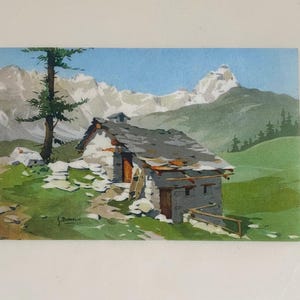 May include: A vintage postcard featuring a watercolor painting of a stone cottage nestled in a mountain landscape. The cottage has a gray slate roof and a wooden door. A tall evergreen tree stands to the left, and snow-capped mountains are in the background.