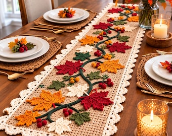 May include: A rectangular beige crochet table runner featuring a central dark green vine motif adorned with crocheted maple leaves in shades of red, orange, and cream, accented with small red and yellow berries and a scalloped cream-colored border.