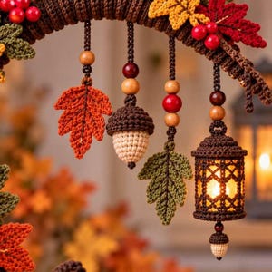 May include: A crochet autumn wreath featuring a brown base adorned with red, yellow, and green crocheted leaves and red berries. Hanging from the wreath are crocheted ornaments including an acorn, leaves, and a lantern with a warm light.
