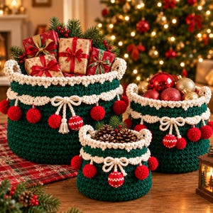 May include: Three dark green crocheted baskets with cream-colored trim, bows, and red pom-poms. The largest basket holds wrapped gifts, the medium basket contains red and gold ornaments, and the smallest basket holds pinecones.