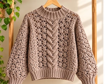 May include: A dusty rose crochet sweater featuring a central vertical cable knit panel, a ribbed mock neck collar, and ribbed cuffs. The body and sleeves are constructed with an openwork floral pattern, creating a textured, lightweight appearance.