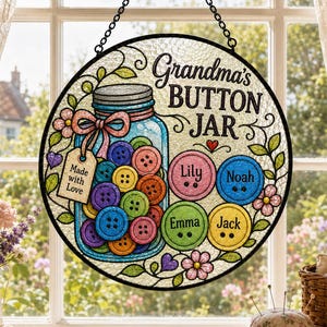 May include: A circular stained glass suncatcher featuring a jar filled with colorful buttons and the text Grandma's BUTTON JAR. Four large buttons are personalized with the names Lily, Noah, Emma, and Jack, surrounded by floral vines and a tag.
