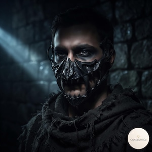 May include: A black, textured, rigid face mask featuring sharp, fang-like protrusions covering the nose and mouth area. The mask has a dark, matte finish with intricate, sculpted details and is worn over a dark, frayed, hooded garment.
