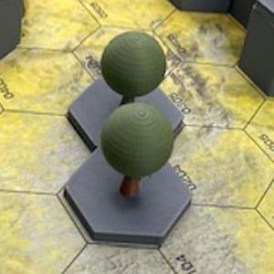 May include: Two miniature green tree models with brown trunks are placed on gray hexagonal platforms. The platforms are arranged on a yellow and brown game board. The trees have a spherical shape, and the game board has printed text.