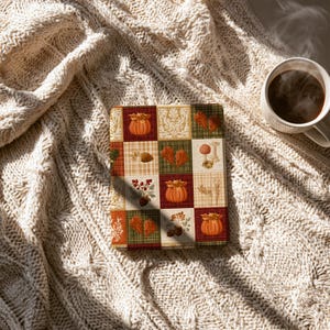 May include: A rectangular e-reader cover featuring a patchwork design of autumn-themed squares. The pattern includes illustrations of orange pumpkins, red and brown oak leaves, acorns, berries, and wheat stalks set against plaid and damask backgrounds.