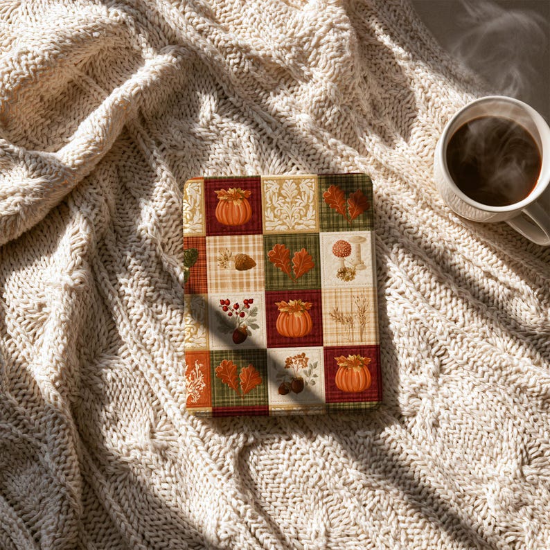 May include: A rectangular e-reader cover featuring a patchwork design of autumn-themed squares. The pattern includes illustrations of orange pumpkins, red and brown oak leaves, acorns, berries, and wheat stalks set against plaid and damask backgrounds.