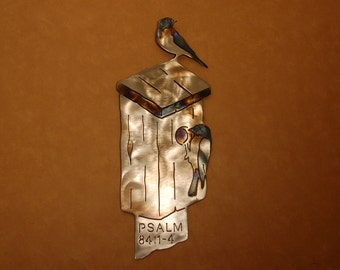 Metal wall sculpture of birdhouse with bluebirds