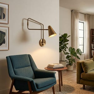 May include: A wall-mounted swing arm lamp with a metallic brass finish and a conical shade. The fixture features a circular base plate with a small knob and an adjustable arm structure that extends outward to provide directional lighting.