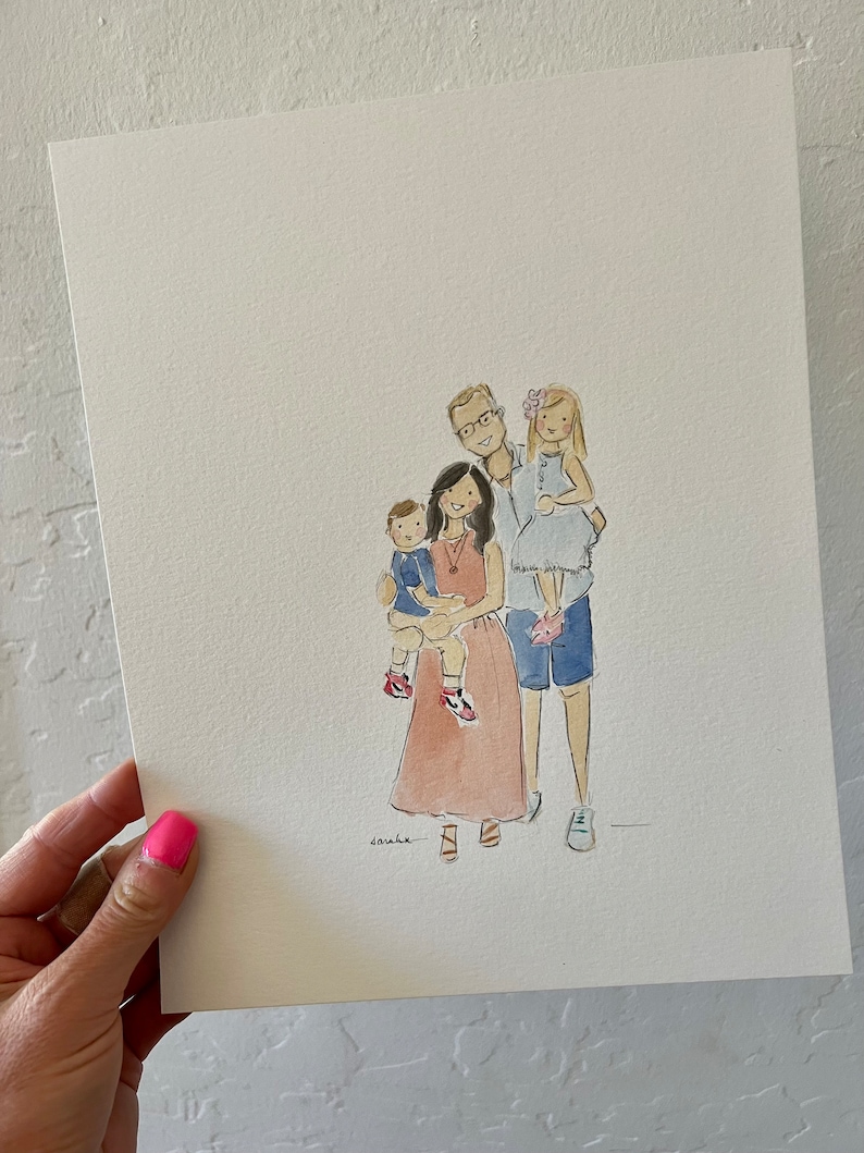 May include: Watercolor family portrait on paper. The artwork depicts a family of four, with the parents and two children. The mother wears a peach dress, and the father holds the older child. The artist's signature is visible.