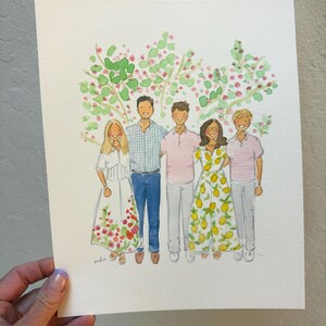 May include: Watercolor portrait of five people standing in front of a tree with green and pink foliage. The people are wearing various outfits, including dresses and shirts. The artwork is on white paper and held by a hand.