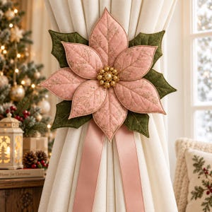 May include: A fabric curtain tieback featuring a large, quilted pink poinsettia flower with gold leaf accents and dark green leaves. The center of the flower is adorned with a cluster of gold beads. Two long, smooth pink ribbons hang downward.