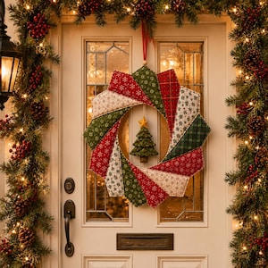 May include: A fabric wreath featuring a starburst pattern of quilted segments in red, green, and cream with snowflake and plaid prints. A small, three-dimensional green fabric Christmas tree with a yellow star topper hangs in the center.