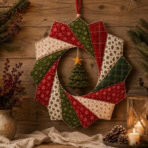 May include: A circular fabric wreath featuring a starburst pattern of quilted segments in red, green, and cream with snowflake and plaid prints. A small, stuffed green fabric Christmas tree with a yellow star topper hangs in the center.