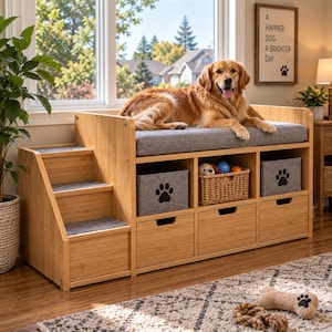 May include: A light wood pet bed with three integrated steps on the left side, a gray cushioned top, and three storage compartments below. Two compartments feature gray fabric bins with black paw print icons, and one holds a woven basket.
