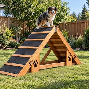 May include: An A-frame dog agility ramp constructed from natural wood with a black non-slip textured surface on the incline. The structure features horizontal wooden slats for traction and side panels with decorative cutouts shaped like paw prints.