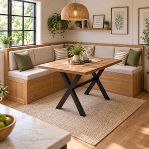 May include: A wooden corner dining bench with light beige cushions and olive green and striped throw pillows. A rectangular wooden table with a black metal X-shaped base sits in front of the bench. A woven dome pendant light hangs above.