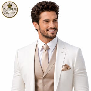 May include: A white blazer worn over a beige vest and a white collared shirt with a matching beige necktie and pocket square. The Imperial Crown logo is visible in the upper left corner. The ensemble features a clean, structured design.