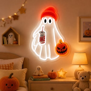 May include: A white neon ghost sign featuring a bright orange beanie, holding a Diet Coke can with a red and white striped straw, and carrying a carved orange jack-o'-lantern pumpkin. The ghost has a simple outline and two black oval eyes.