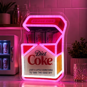 May include: A neon sign shaped like a cigarette pack with a Diet Coke logo and the text "JUST A LITTLE SOMETHING TO TAKE THE EDGE OFF" and "FRIDGE CIGS". The sign features bright pink and white neon tubing and holds several silver soda cans.