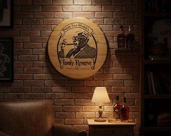 May include: A circular wooden wall sign featuring a black graphic of a man smoking a cigar, with the text "Pappy Van Winkle's Family Reserve" printed in a decorative banner style. The sign is constructed from light-colored wood planks.