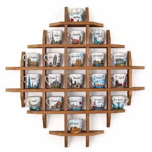May include: A diamond-shaped wooden wall shelf with a grid structure holding nineteen ceramic mugs. Each mug features a colorful illustration of a global city, including Baku, Paris, London, New York, Rome, Pisa, Barcelona, Amsterdam, Athens, Dubai, Istanbul, Prague, Sydney, Tokyo, Venice, Florence, Budapest, San Francisco, Rio de Janeiro, and Cairo.