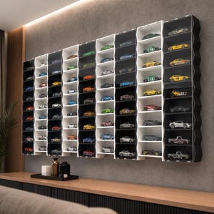 May include: A large wall-mounted display case featuring multiple vertical columns with individual shelves. The unit contains numerous miniature toy cars in various colors, including yellow, red, blue, green, and silver, arranged neatly within the compartments.
