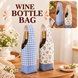 May include: Two fabric wine bottle bags with handles. One bag features a blue and white gingham check pattern, while the other has a small blue floral print on a cream background. Both have solid blue bases and contain wine bottles.
