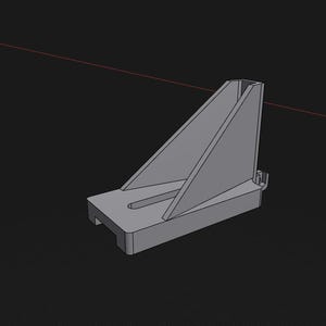 May include: A grey, three-dimensional computer-generated model of a mechanical bracket. The object features a flat rectangular base with a central slot and a triangular vertical support fin extending upwards from the top surface of the base.