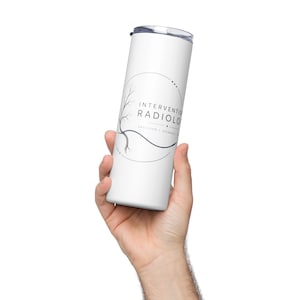 May include: A white cylindrical tumbler featuring a black graphic design with a circular frame, a tree-like branch element, and the text "INTERVENTIONAL RADIOLOGY" followed by "PRECISION GUIDANCE" in a clean, sans-serif font.
