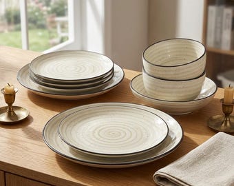 May include: A dinnerware set featuring off-white ceramic plates and bowls with a subtle spiral pattern, speckled texture, and dark brown rims. The collection includes stacked plates and bowls, arranged to showcase the circular design and finish.