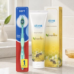 May include: A soft toothbrush in blue and red packaging labelled 'Extra Clean' and '1 BRUSH' next to a tube and box of Atomy Propolis toothpaste. The packaging features a yellow gradient, honeycomb patterns, and bee imagery with 200g net weight.