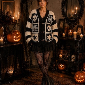 May include: A black and cream crochet cardigan featuring a V-neckline, toggle closures, and square patches with skull, spiderweb, and star motifs. The sleeves and body are designed with alternating horizontal stripes of black and cream yarn.