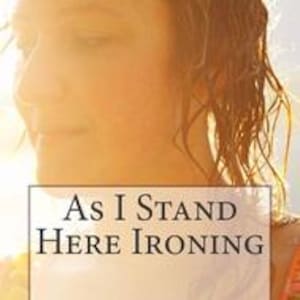 May include: A rectangular graphic featuring a soft-focus, warm-toned portrait of a person with wavy hair, overlaid with a white box containing the black serif text "As I Stand Here Ironing" centered in the lower portion of the image.