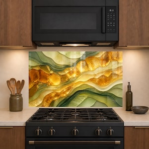 May include: A rectangular kitchen backsplash panel featuring an abstract fluid art design with flowing layers of sage green, olive, and vibrant amber gold. The glossy surface displays organic, wave-like patterns that create a sense of depth and movement.