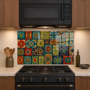May include: A kitchen backsplash panel featuring a collage of colorful square tiles with intricate floral and geometric patterns in shades of red, blue, green, and yellow, positioned behind a black gas stove and below a black microwave oven.