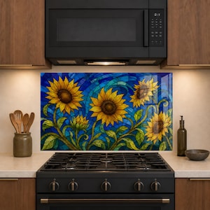 May include: A rectangular kitchen backsplash panel featuring a vibrant stained glass style illustration of four yellow sunflowers with green stems and leaves set against a deep blue and turquoise mosaic background, positioned behind a black gas stove.
