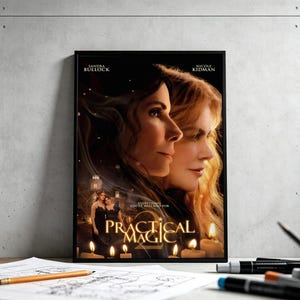 May include: A rectangular movie poster for Practical Magic 2 featuring portraits of Sandra Bullock and Nicole Kidman. The title Practical Magic 2 is in gold lettering at the bottom, with small figures of two people and lit candles in the foreground.