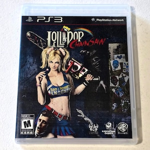 May include: A PlayStation 3 video game case for Lollipop Chainsaw featuring a blonde character in a blue cheerleader uniform holding a chainsaw. The cover art includes the text San Romero Knights, the ESRB Mature 17+ rating, and logos for Kadokawa Games and WB Games.