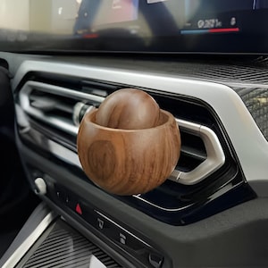 Houten auto-olieverspreider: bolvormige geurdispenser met clip voor in het ventilatierooster, gemaakt van natuurlijk hout.