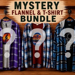 May include: A mystery flannel and t-shirt bundle featuring three sets of shirts hanging on hangers. The left set is a purple plaid flannel over a gray t-shirt, the center is a blue plaid flannel over a maroon t-shirt, and the right is a blue plaid hooded flannel over a black t-shirt.